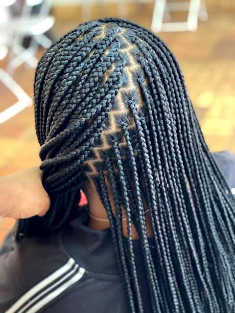 The back of a long box braid install, the zig-zag parting grid clear across the crown
