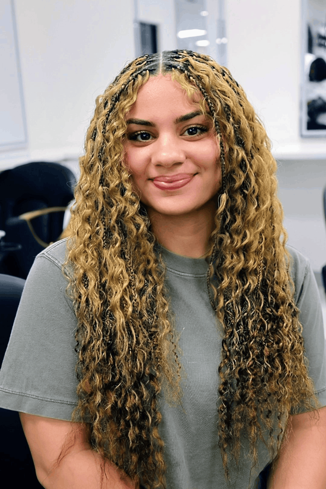 Honey blonde boho braids worn down past the chest, curls spiralling out along the full length