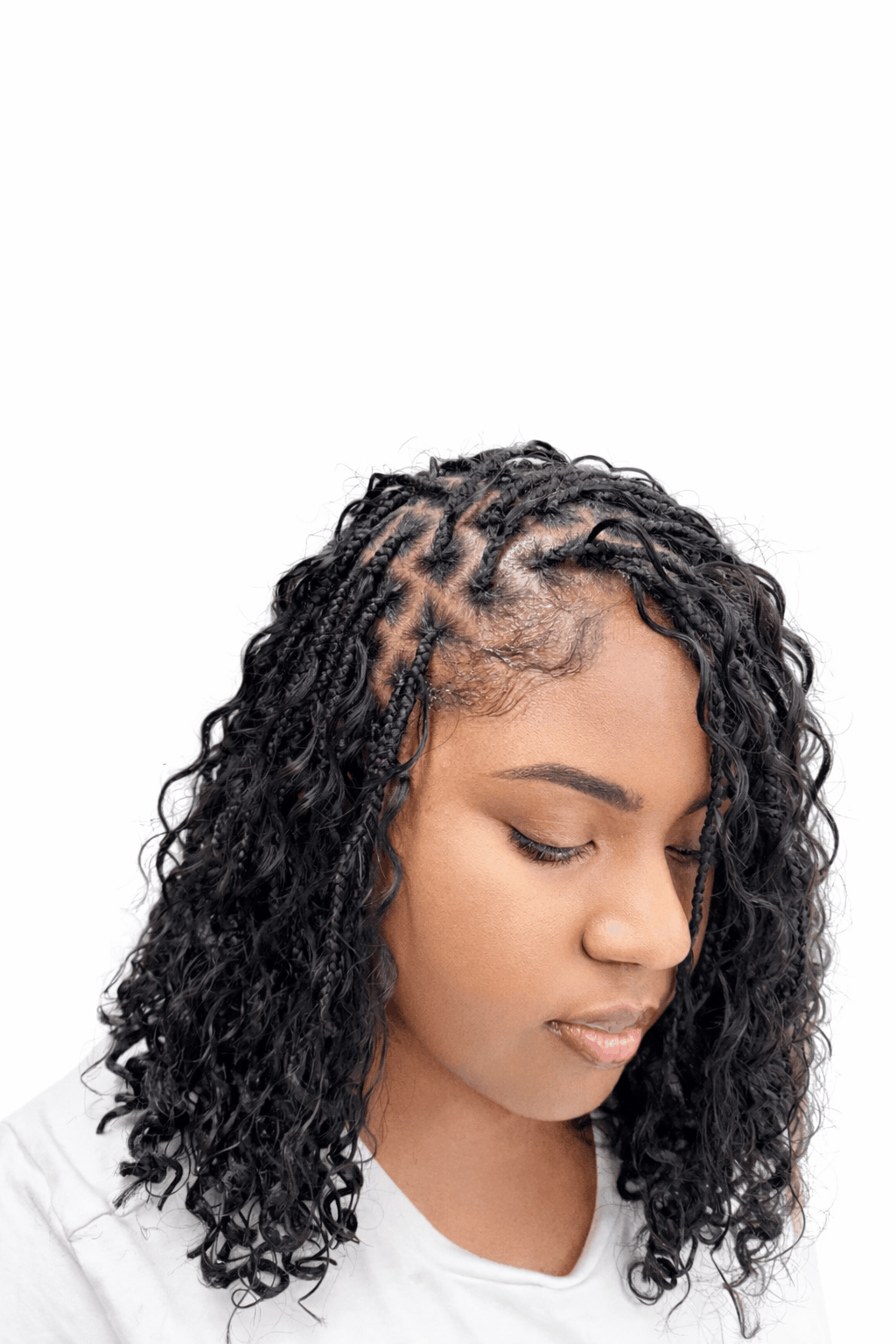 Shoulder-length black boho braids with a square parting grid visible at the crown