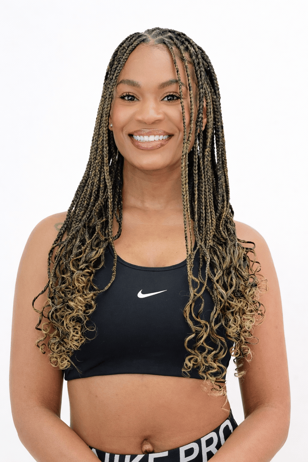 Fulani braids in honey blonde with curly ends, front view, Jalia Walda Salon Houston TX