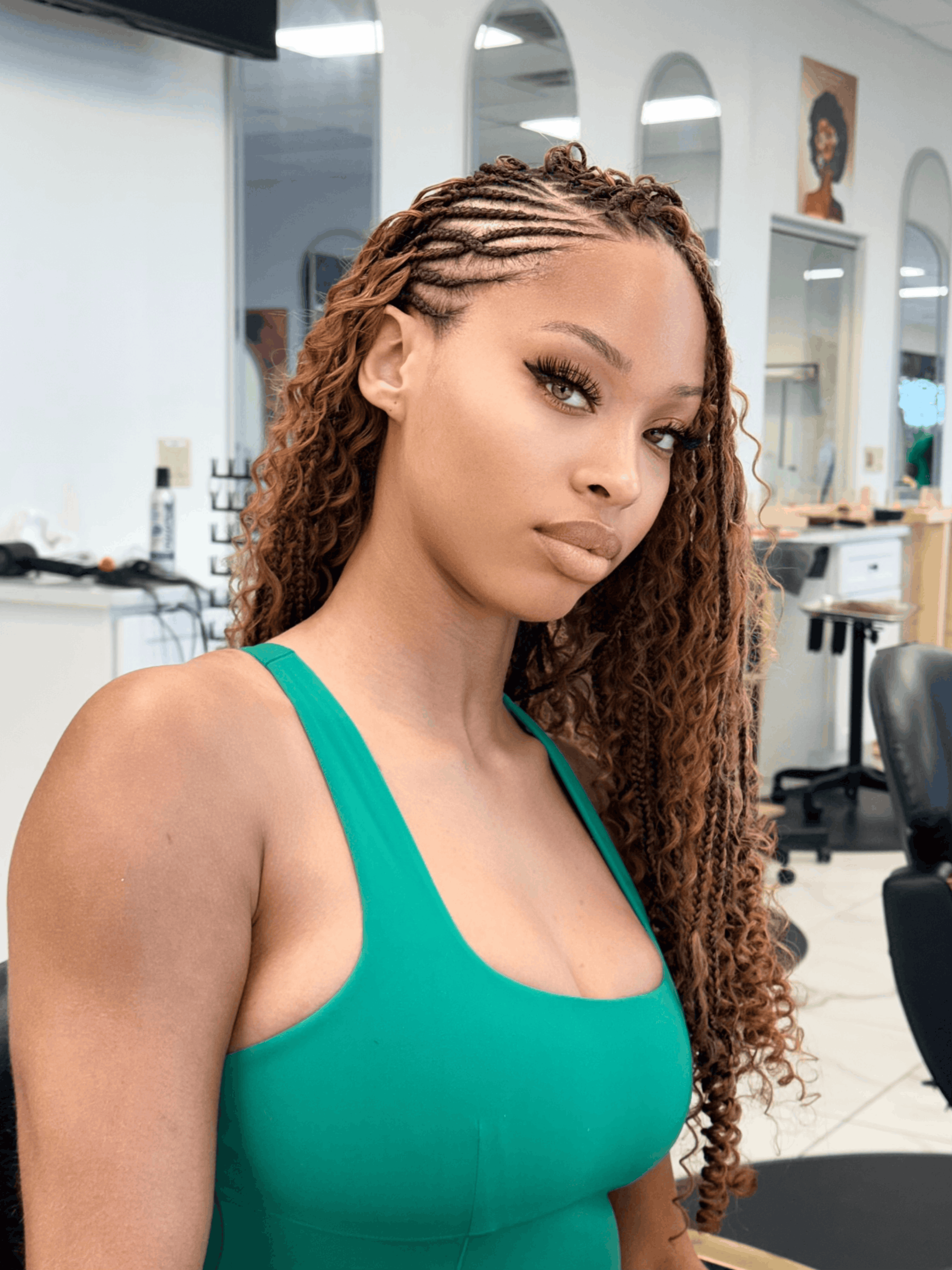 Flip over Fulani braids in copper, side cornrows along the hairline with long curly lengths, braided in our Houston salon