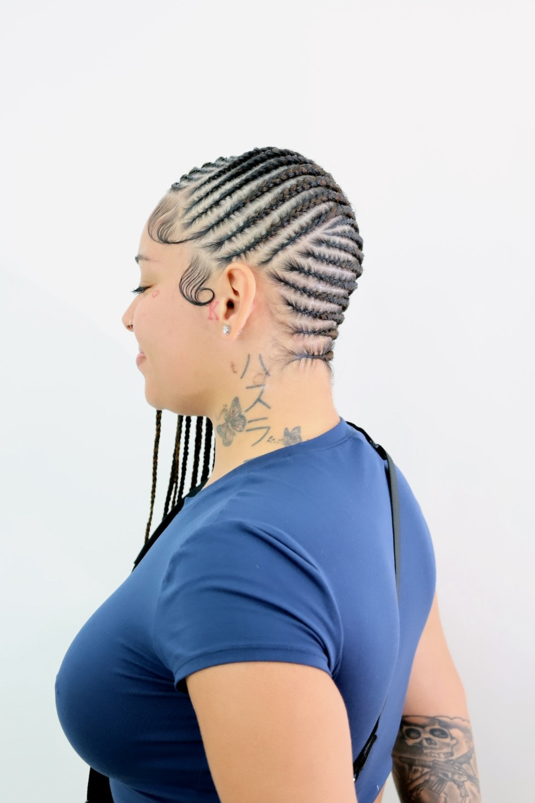 A close side view of lemonade braids showing the even feed-in rows and the clean scalp partings between them