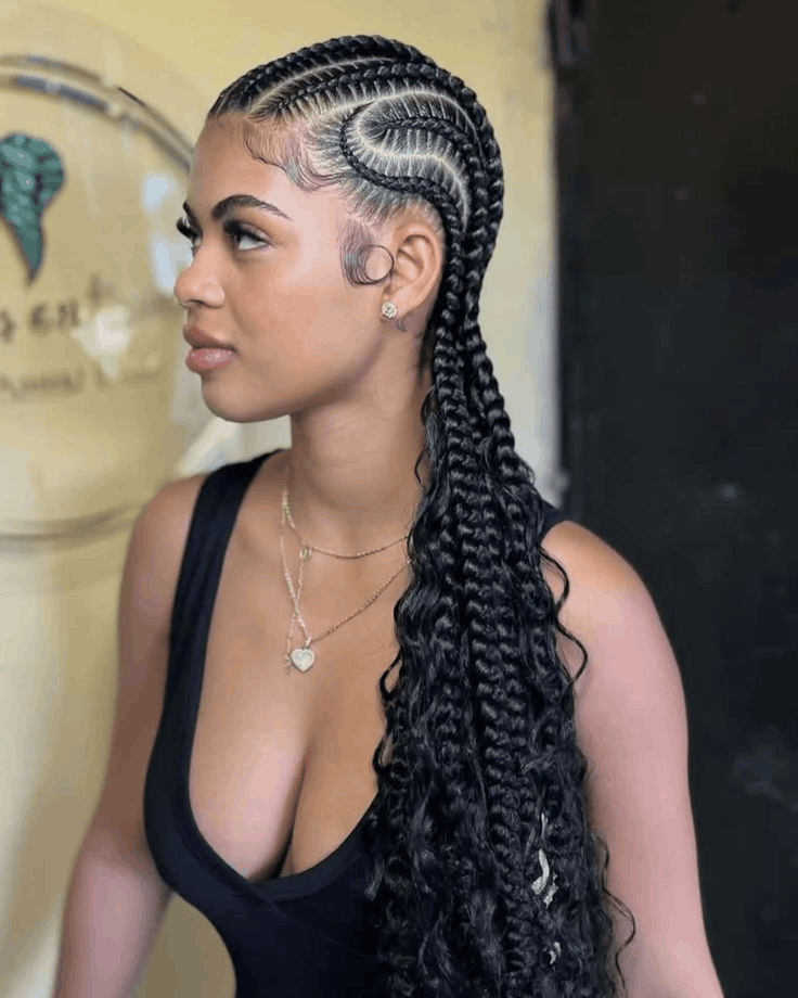 Stitch braids curving back and finished with long curly ends, side view, Jalia Walda Salon Houston TX