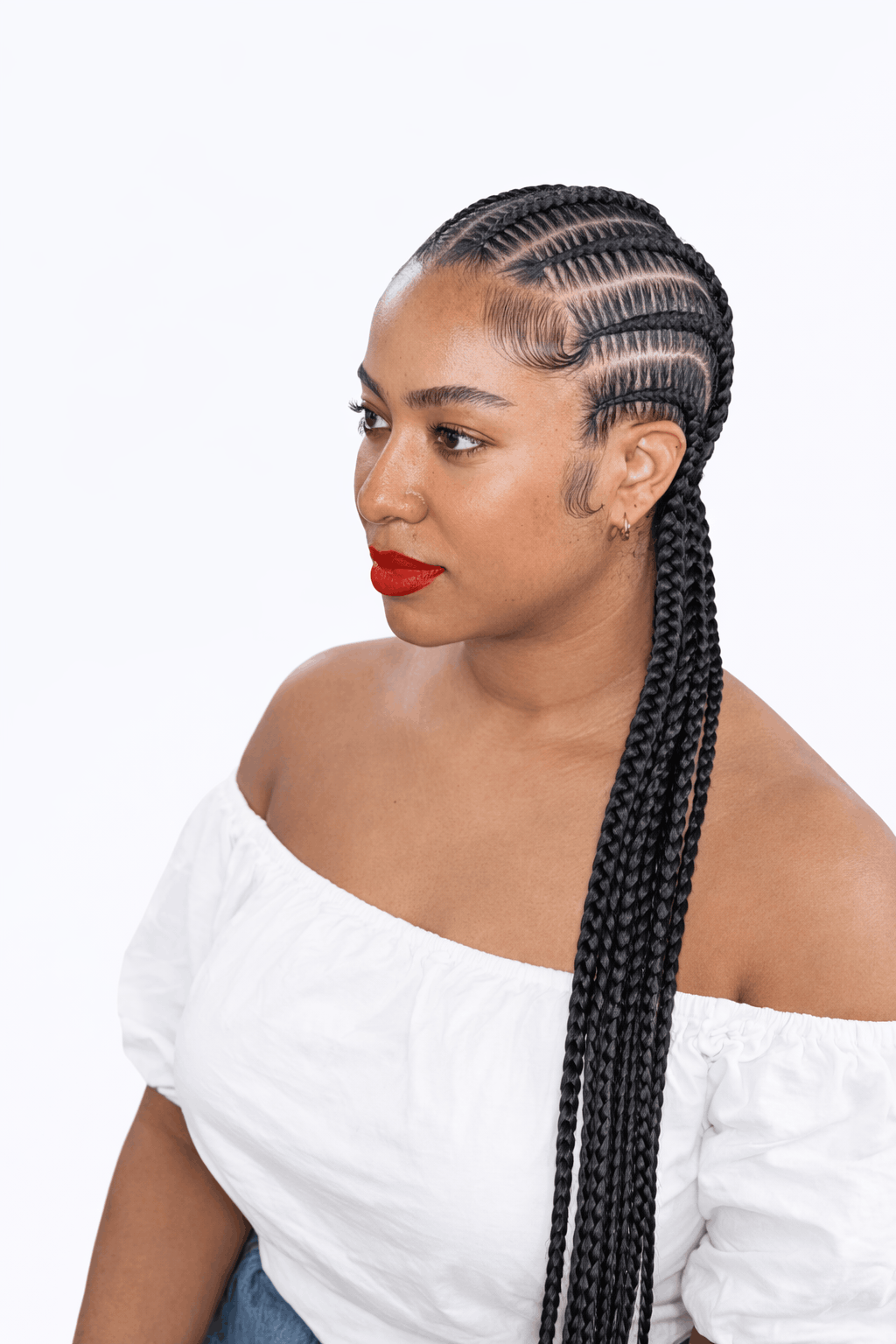 Stitch braids braided straight back, the clean stitched divisions running from the hairline down each cornrow, Jalia Walda Salon Houston TX
